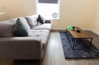 a living room with a couch and a coffee table at Seaside Retreat - 2BR Apt in Southport in Southport