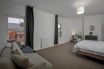 a living room with a couch and a bed at Blackpool Central Springfield Apartments Spacious Comfort in Blackpool