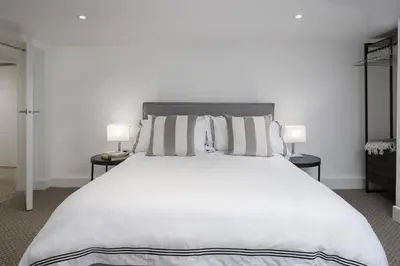 a bedroom with a large white bed with two lamps at Blackpool Central Springfield Apartments Spacious Comfort in Blackpool