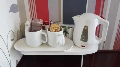 a shelf with two coffee cups and a blender at Valdene Hotel in Blackpool