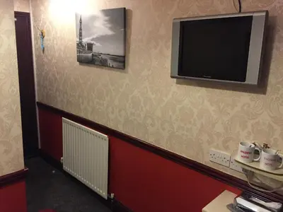 a room with a flat screen tv on the wall at Valdene Hotel in Blackpool