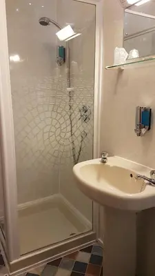 a bathroom with a shower and a sink at Valdene Hotel in Blackpool