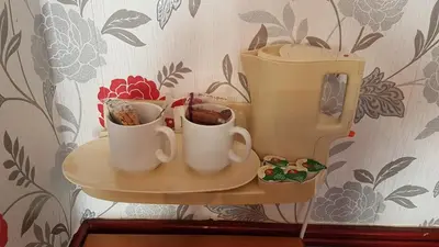 a shelf with cups on it in a room at Valdene Hotel in Blackpool