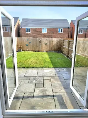 an open window view of a yard with a fence at Seaside beach themed home with garden and driveway in Lytham St Annes