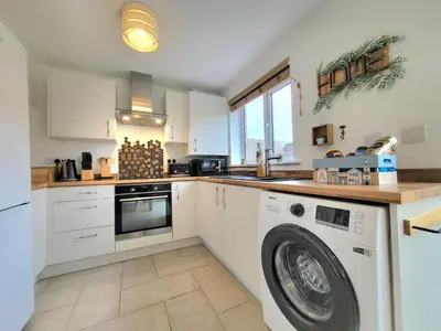 a kitchen with a washer and a washing machine at Seaside beach themed home with garden and driveway in Lytham St Annes