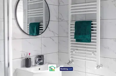 a white bathroom with a mirror and a sink at Three Bedroom House in Preston in Preston
