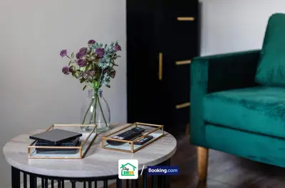 a vase of flowers on a table next to a couch at Three Bedroom House in Preston in Preston
