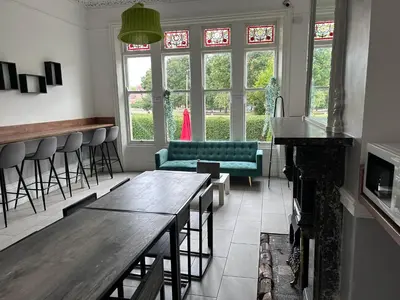 a bar with a couch and a table in a room at Triple room Private Bath Near LFC Free Street Parking No Breakfast in Liverpool