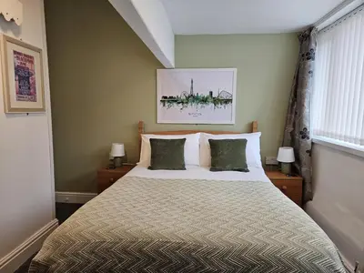 a bedroom with a bed and two lamps and a window at Beverley Dean - Children Over 5 Years Welcome - Continental Breakfast in Blackpool