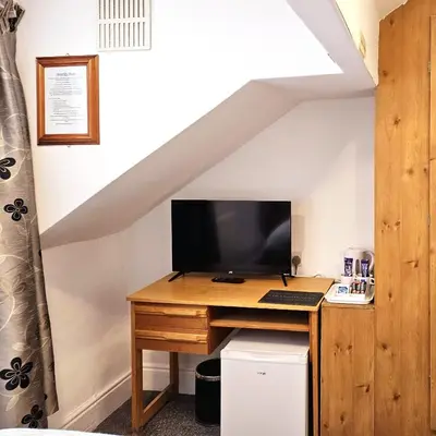 a desk with a computer on it in a attic at Beverley Dean - Children Over 5 Years Welcome - Continental Breakfast in Blackpool