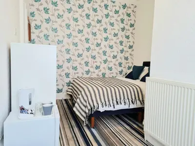 a bedroom with a bed with a blanket on it at Beverley Dean - Children Over 5 Years Welcome - Continental Breakfast in Blackpool