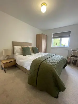 a bedroom with a large bed and a window at Cosy home close to M6 motorway in Pemberton