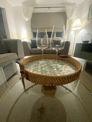 a living room with a table and two wine glasses at Cosy home close to M6 motorway in Pemberton
