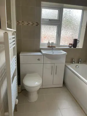 a bathroom with a toilet and a sink and a tub at Cosy home close to M6 motorway in Pemberton