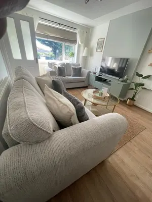 a living room with a couch and a television at Cosy home close to M6 motorway in Pemberton