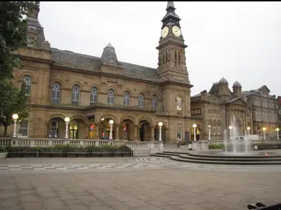 a large building with a clock tower and a fountain at The Hideaway ll private garden Quiet Central in Southport