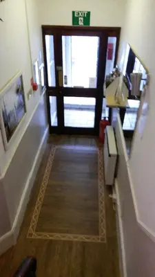 a hallway with a door in a building at The Manuela Rose in Blackpool