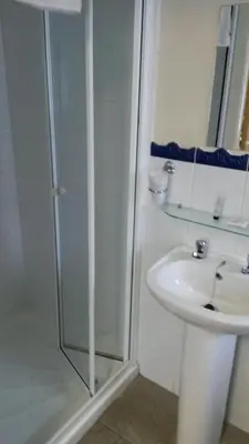 a bathroom with a shower and a sink at The Manuela Rose in Blackpool