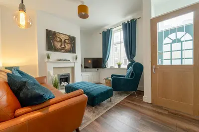 a living room with a couch and a chair at Kirkmoor Cottage - Cosy home central Clitheroe in Clitheroe