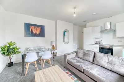 a living room with a couch and a table at Fairhaven View by Guestz in Lytham St Annes