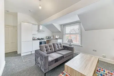 a living room with a couch and a table at Fairhaven View by Guestz in Lytham St Annes