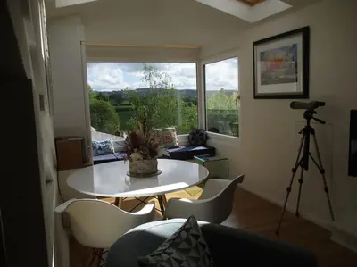a living room with a table and chairs and a camera at TOPC - Old Posthouse Flat in Garstang