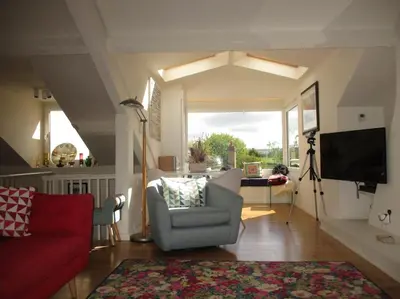 a living room with a red couch and a tv at TOPC - Old Posthouse Flat in Garstang