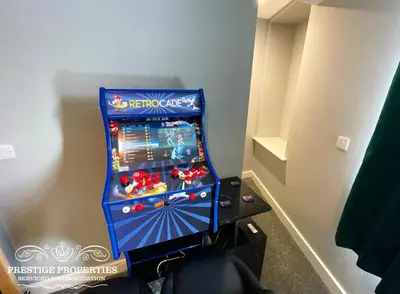 a video game machine in a corner of a room at Orange View by Prestige Properties SA in Haverigg