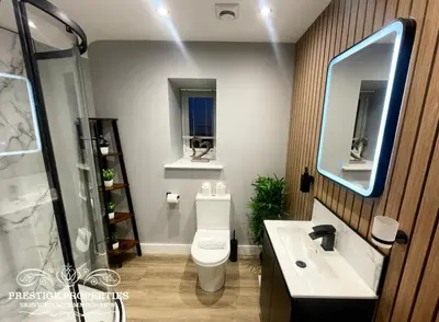 a bathroom with a toilet and a sink and a shower at Orange View by Prestige Properties SA in Haverigg