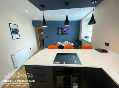 a kitchen with orange chairs and a dining room at Orange View by Prestige Properties SA in Haverigg