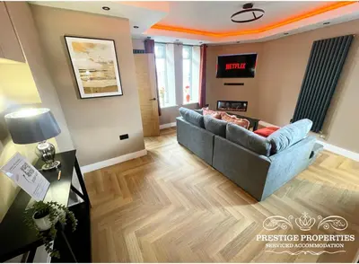 a living room with a couch and a television at Orange View by Prestige Properties SA in Haverigg