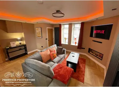 a living room with a couch and a tv at Orange View by Prestige Properties SA in Haverigg