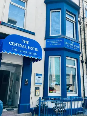 a building with blue signs on the side of it at Tower Central hotel Albert Road in Blackpool