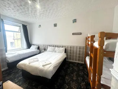 a bedroom with two bunk beds and a window at Tower Central hotel Albert Road in Blackpool