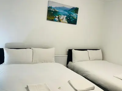 two beds sitting next to each other in a room at Tower Central hotel Albert Road in Blackpool
