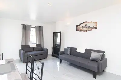 a living room with a couch and a chair at 2 bed 2 bath city centre sleep 7 in Liverpool