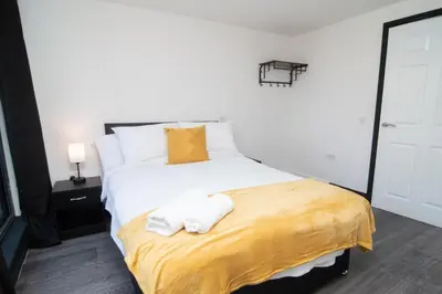 a bedroom with a bed with two towels on it at 2 bed 2 bath city centre sleep 7 in Liverpool