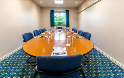 a large conference room with a long table and chairs at Britannia Hotel Wigan in Standish