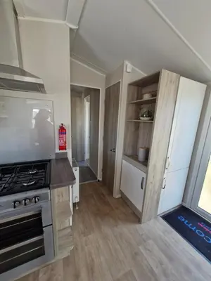 a kitchen with a stove and a counter top at Willaby skye in Heysham