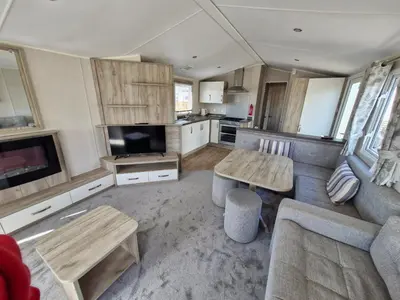 a living room with a couch and a table at Willaby skye in Heysham