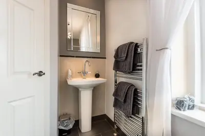 a bathroom with a sink and a mirror at Glen Guest House in Blackpool
