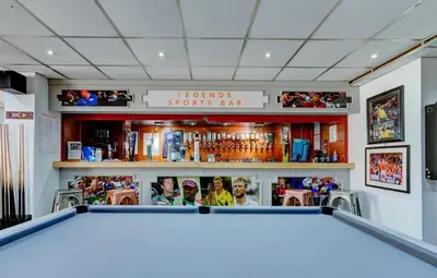 a pool table in a bar with three people behind it at The Sandringham Court Hotel & Apartment Welcoming Large and Small Groups for 16 years in Blackpool
