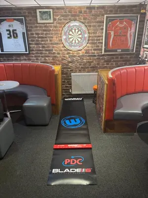 a ping pong table in a room with couches and a wall with at The Sandringham Court Hotel & Apartment Welcoming Large and Small Groups for 16 years in Blackpool