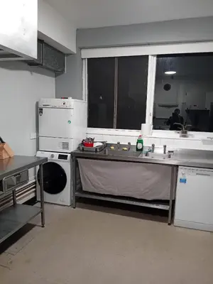 a kitchen with a sink and a dishwasher at Single Room with Private Bath Free Street Parking Near LFC No Breakfast in Liverpool