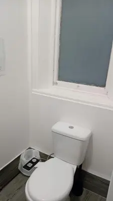 a white bathroom with a toilet and a window at Single Room with Private Bath Free Street Parking Near LFC No Breakfast in Liverpool