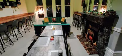 a living room with a fireplace and a bar at Single Room with Private Bath Free Street Parking Near LFC No Breakfast in Liverpool