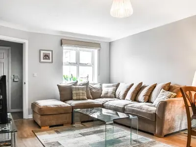 a living room with a couch and a glass table at Church View in Longridge
