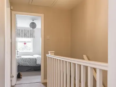 a bedroom with a staircase and a bed in a window at Church View in Longridge