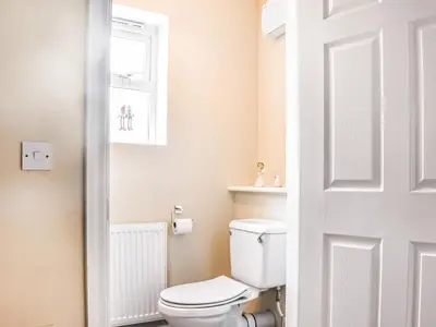 a bathroom with a white toilet and a window at Church View in Longridge