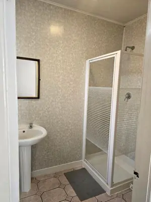 a bathroom with a shower and a sink at Wilsons Lodge in Blackpool